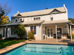 a house with a swimming pool in front of it at Limonite Guesthouse in Pretoria
