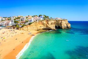 an aerial view of a beach with people on it at Casa Sem Pressa - Beach, Pool & Central Carvoeiro in Carvoeiro