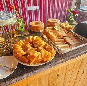 a buffet with bread and pastries on a table at Wadi Rum Panorama Suites in Disah