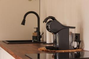 a coffee maker sitting on a counter in a kitchen at Sakų Apartamentai in Varėna