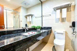 a bathroom with a sink and a toilet at Dayi Yihao hotel in Xiamen