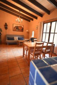 a living room with a table and chairs and a couch at Finca Caballo Blanco in Montuiri