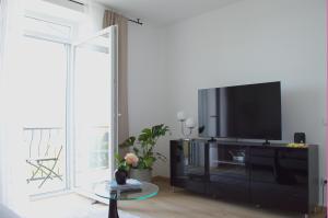 a living room with a flat screen tv on a entertainment center at Maslina in Crikvenica