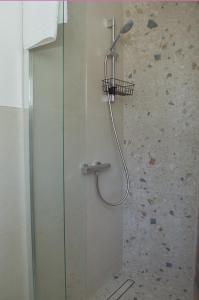 a shower with a shower head in a bathroom at Maslina in Crikvenica +9 photos