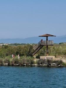 people are sitting on a bridge over a body of water at EL Niu del Delta in Deltebre