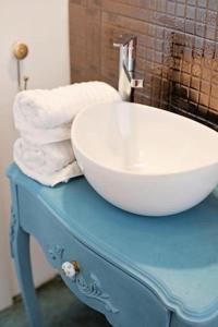 a sink on top of a blue table with towels at Moft Loft. Lovely, comfy apartment. in Cluj-Napoca +59 photos
