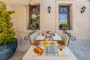a table with several plates of food on it at Karis Cave Cappadocia in Ürgüp