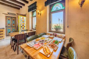a dining room with a table with food on it at Karis Cave Cappadocia in Ürgüp
