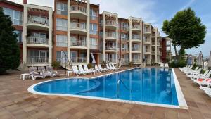a swimming pool in front of a building at VP Bellevue in Ravda