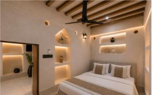 a bedroom with a bed in a room with lights at Nomad Inn Al Bustan in Nizwa