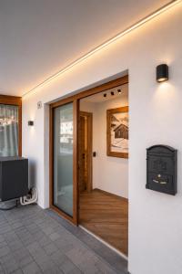 a door to a room with a television and a door to a room at La Stua de Anny by AMA Val di Fassa in Pozza di Fassa