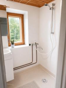 a bathroom with a shower and a sink at Villa Ralli in Jämsä