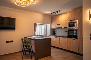 a kitchen with wooden cabinets and a counter top at La Stua de Anny by AMA Val di Fassa in Pozza di Fassa