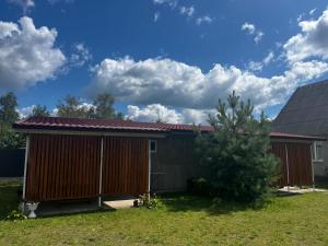 a house with a red roof and a tree at Будиночок Перший rio de pulmo in Pulʼmo +3 photos