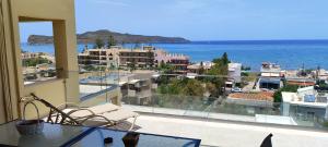 a balcony with a view of the ocean and buildings at Rubini Homes in Agia Marina Nea Kydonias