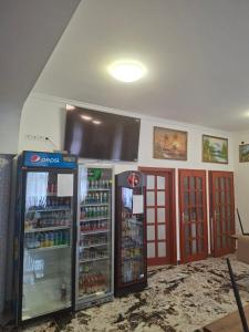a store with two refrigerators in a room at Kitti Panzió in Tiszadada