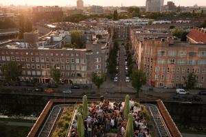 a crowd of people standing in a city at Hotel Casa Amsterdam in Amsterdam