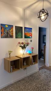 a room with two shelves with flowers on the wall at Follies Garden Room in Dungarvan