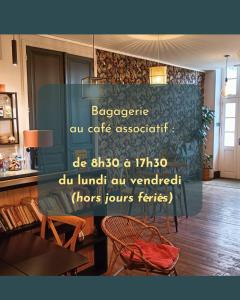 a sign in a room with a table and chairs at Escales patrimoniales en cœur de ville in Poitiers