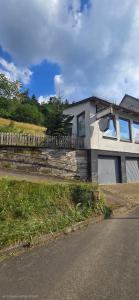 a house sitting on the side of a road at Meyers FeWo - Hüddingen in Reinhardshausen +8 photos