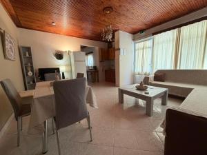 a living room with a table and a couch at Male home in Maletiánoi