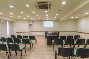 a conference room with chairs and a podium in it at Hotel Eurosol Leiria & Jardim in Leiria