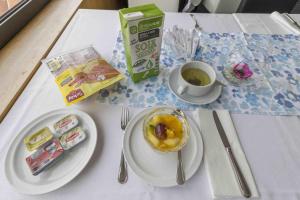 a table with plates of food and a cup of tea at Hotel Eurosol Leiria & Jardim in Leiria