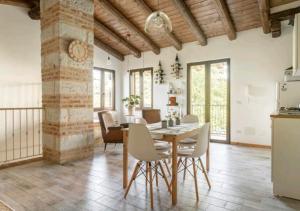 a kitchen and dining room with a table and chairs at Holiday Home Camino Monferrato in Camino