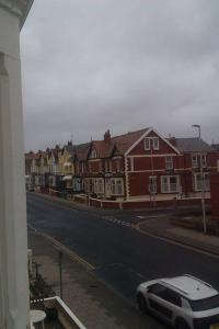 a car parked on the side of a street with houses at Meland (Families ONLY B&B) in Blackpool