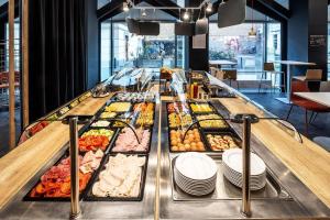 a buffet line with many different types of food at B&B HOTEL Maribor Orel in Maribor +23 photos