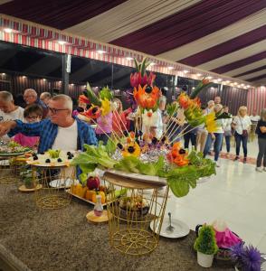 a group of people sitting at tables with flowers on them at Wadi Rum Panorama Suites in Disah