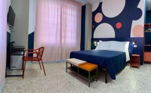 a bedroom with a blue bed and a chair at Magazzino Mediterraneo in Praia a Mare +11 photos