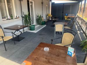 a room with tables and chairs and tables and chairs at Tabacco in Obrenovac