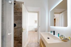 a bathroom with a sink and a mirror at B&B Palazzo del Teatro in Agrigento +63 photos