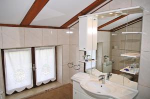 a bathroom with a sink and a mirror at Apartments Petricic with swimming pool in Ičići +24 photos