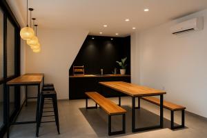 a dining room with two tables and a counter at Houi Hotel in Jodoh