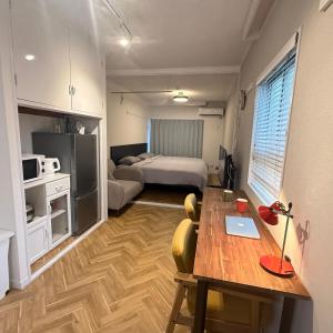 a room with a table and a bed and a bedroom at Sunlife in Sendai