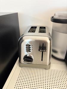 a toaster sitting on a shelf in a kitchen at Tranquil Suite Studio in Wilson