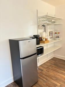 a kitchen with a stainless steel refrigerator in a room at Tranquil Suite Studio in Wilson