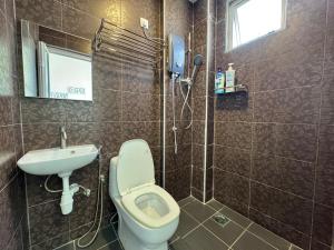 a bathroom with a toilet and a sink at Langkawi Simfoni Beliza Apartment with Sky Pool by Zervin in Kuah +129 photos