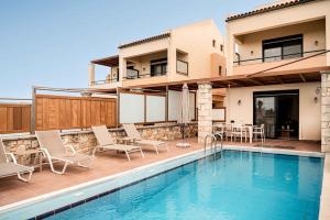 a villa with a swimming pool and a house at Corali Villas - Seaview, Private Pools, 450 to Beach in Kolymvari +91 photos