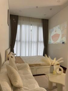 a bedroom with a bed and a large window at Bảo Châm Homestay in Gia Lâm Pho