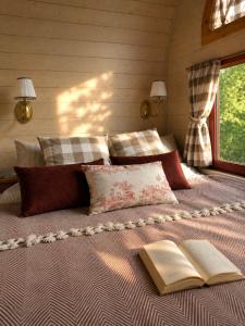 a bedroom with a bed with two books on it at Stativa Przygorze201 Sowie Góry in Przygórze