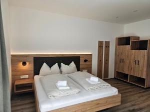 a bedroom with a large white bed with two pillows at Packerhöhe in Pack