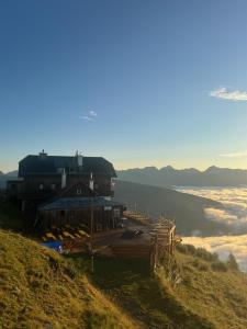 a building on the side of a hill with a view at Speiereckhütte in Mauterndorf