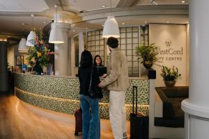 two people standing in front of a hotel lobby at WestCord City Centre Hotel in Amsterdam