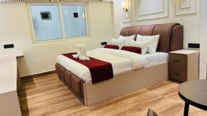 a bedroom with a bed with a stuffed animal on it at Aabuu Babuu Resort & Banquet in Kurseong