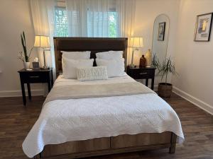 a bedroom with a bed with a home sign on it at Tranquil Suite Studio in Wilson +20 photos