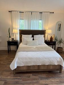 a bedroom with a large bed with a home sign on it at Tranquil Suite Studio in Wilson