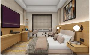 a hotel room with a bed and a television at Hotel Vaarya Inn in Lucknow